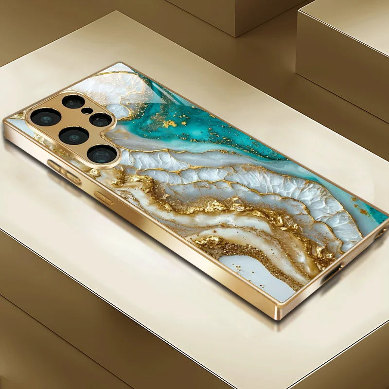 Glass phone case with metallic paint and decorative pattern from Corporación Turística, showcasing a stylish, protective phone cover.