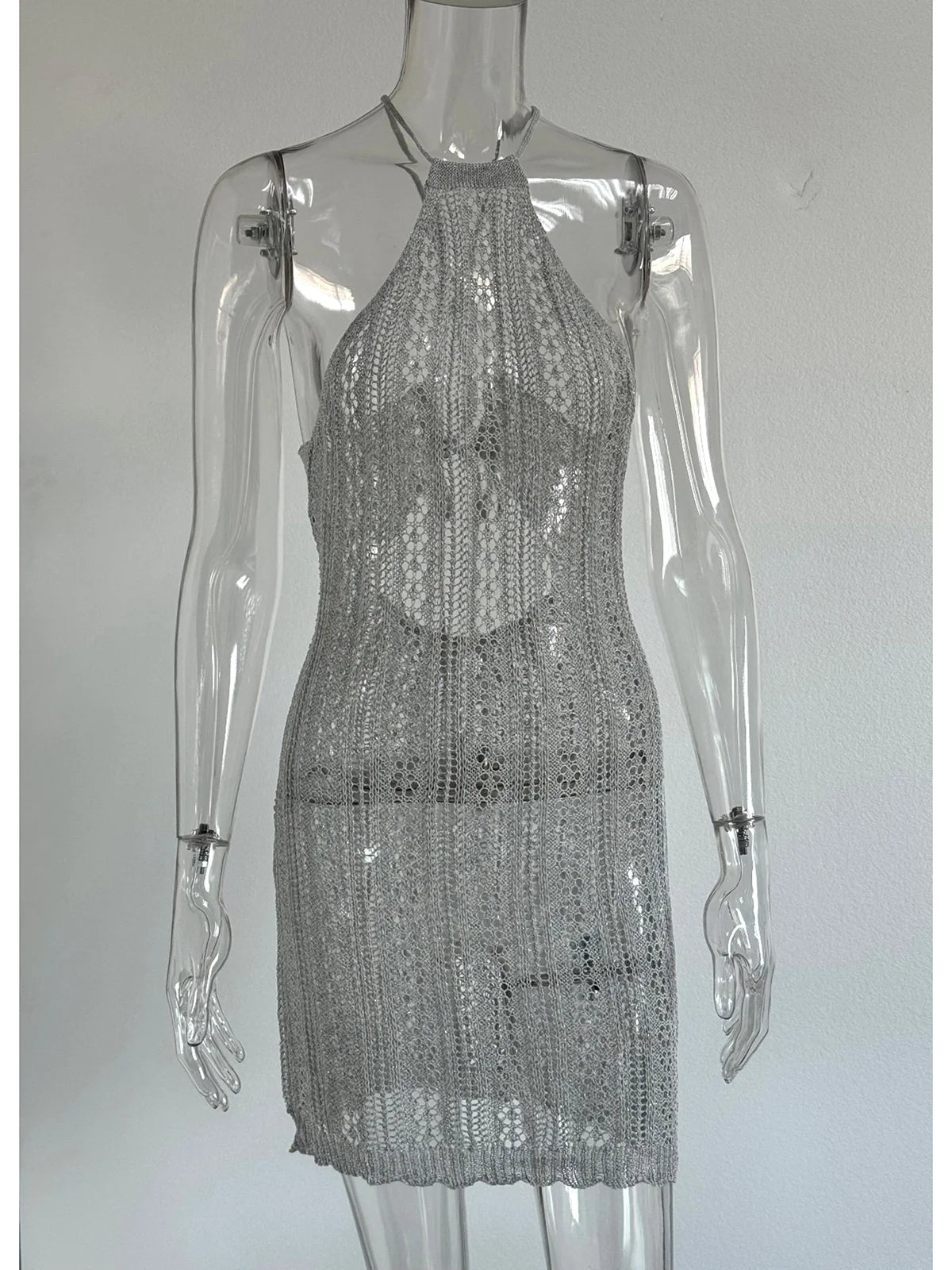 Crochet-knit tunic with open back from Corporación Turística, featuring a flowy design and intricate stitching details.
