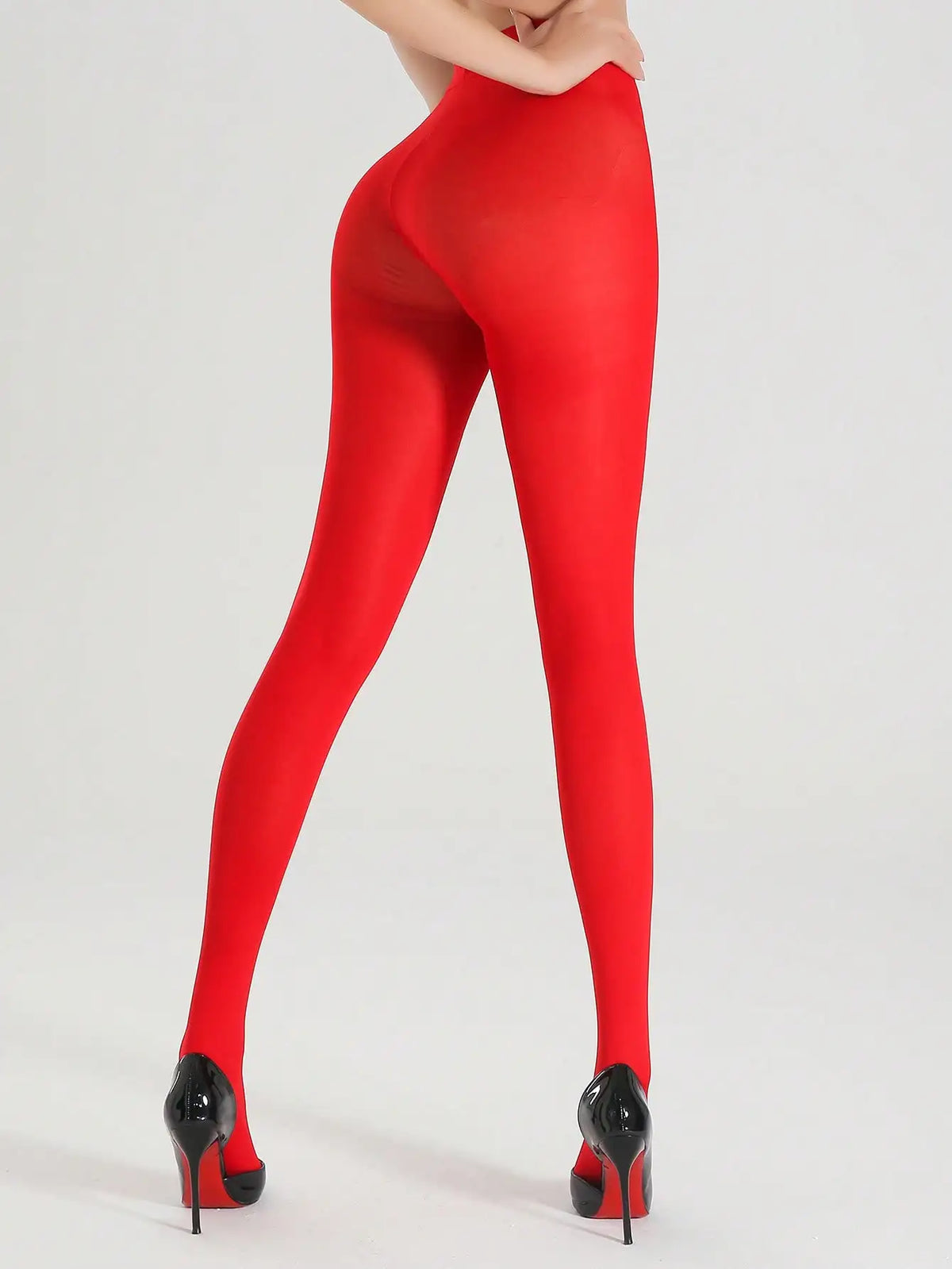Pair of opaque red ultra-elastic nylon pantyhose from Corporación Turística, shown stretched over legs with a smooth finish.