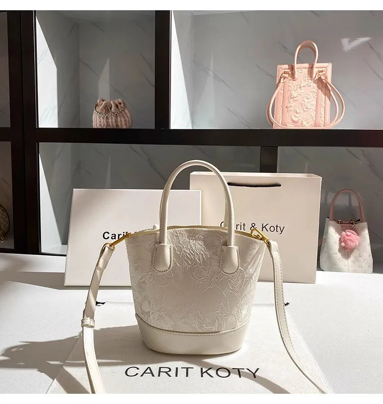 Luxury white embroidered cube-shaped handbag with trendy design, perfect for stylish outfits.