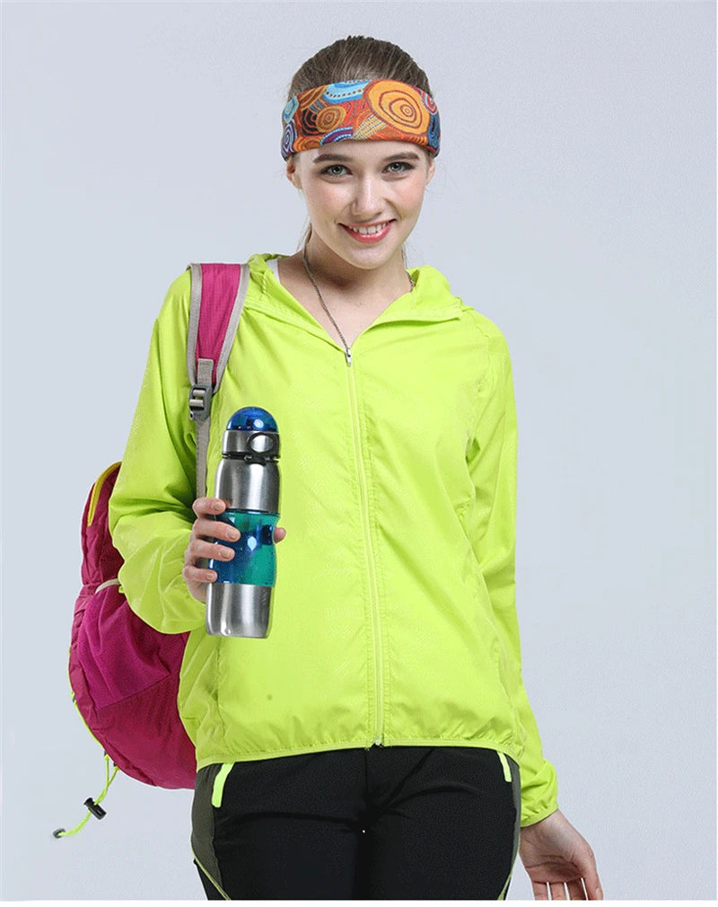 Waterproof camping rain jacket for men and women by Corporación Turística, lightweight outdoor rainwear with a hood.