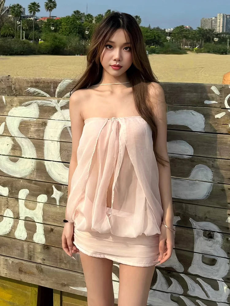 Mini bodycon dress for women by Sisterlinda with a crossover neckline, stylish fit, and vibrant design.