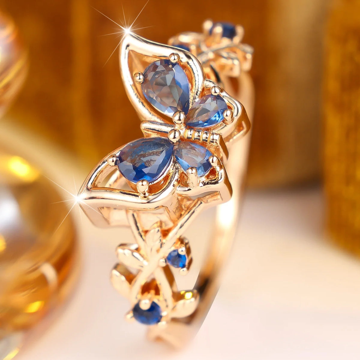 Silver women's toe ring with a blue cubic zirconia stone, featuring a delicate design and polished finish.