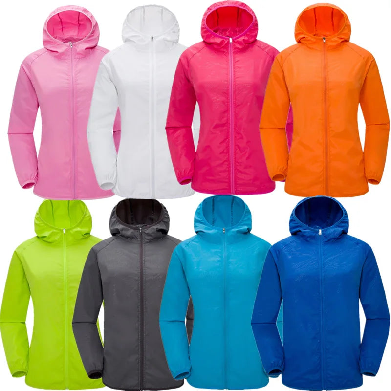 Lightweight waterproof camping rain jacket for men and women by Corporación Turística, shown in a vibrant outdoor setting.