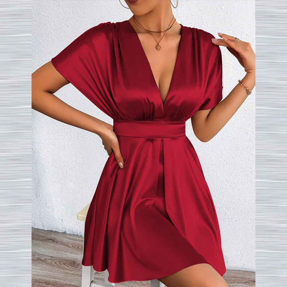 Elegant women's dress with V-neckline and low waist, featuring a sexy design and stylish fit, from Corporación Turística.
