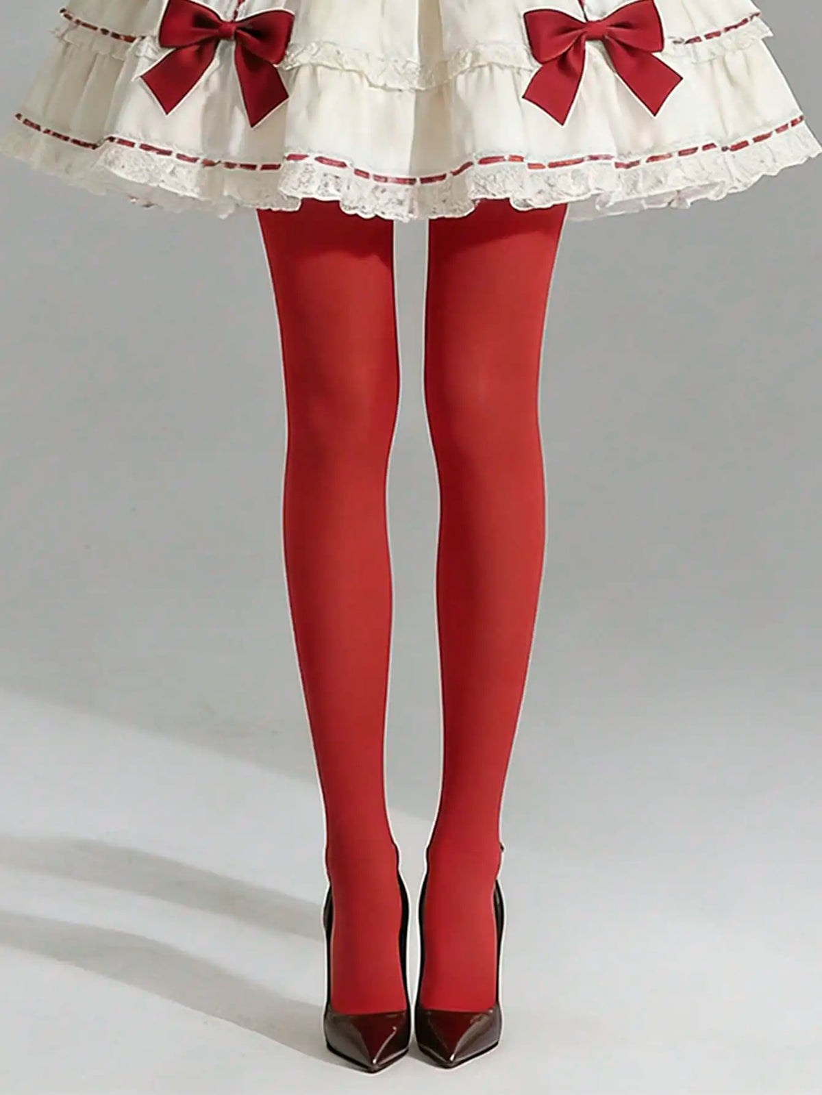 Pair of opaque red ultra-elastic nylon pantyhose from Corporación Turística, showcasing smooth, stretchy fabric and vibrant color.