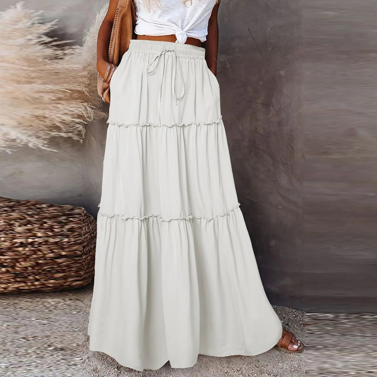 Long women's skirt with solid color and elastic waist, made by Corporación Turística, shown in a stylish fabric.