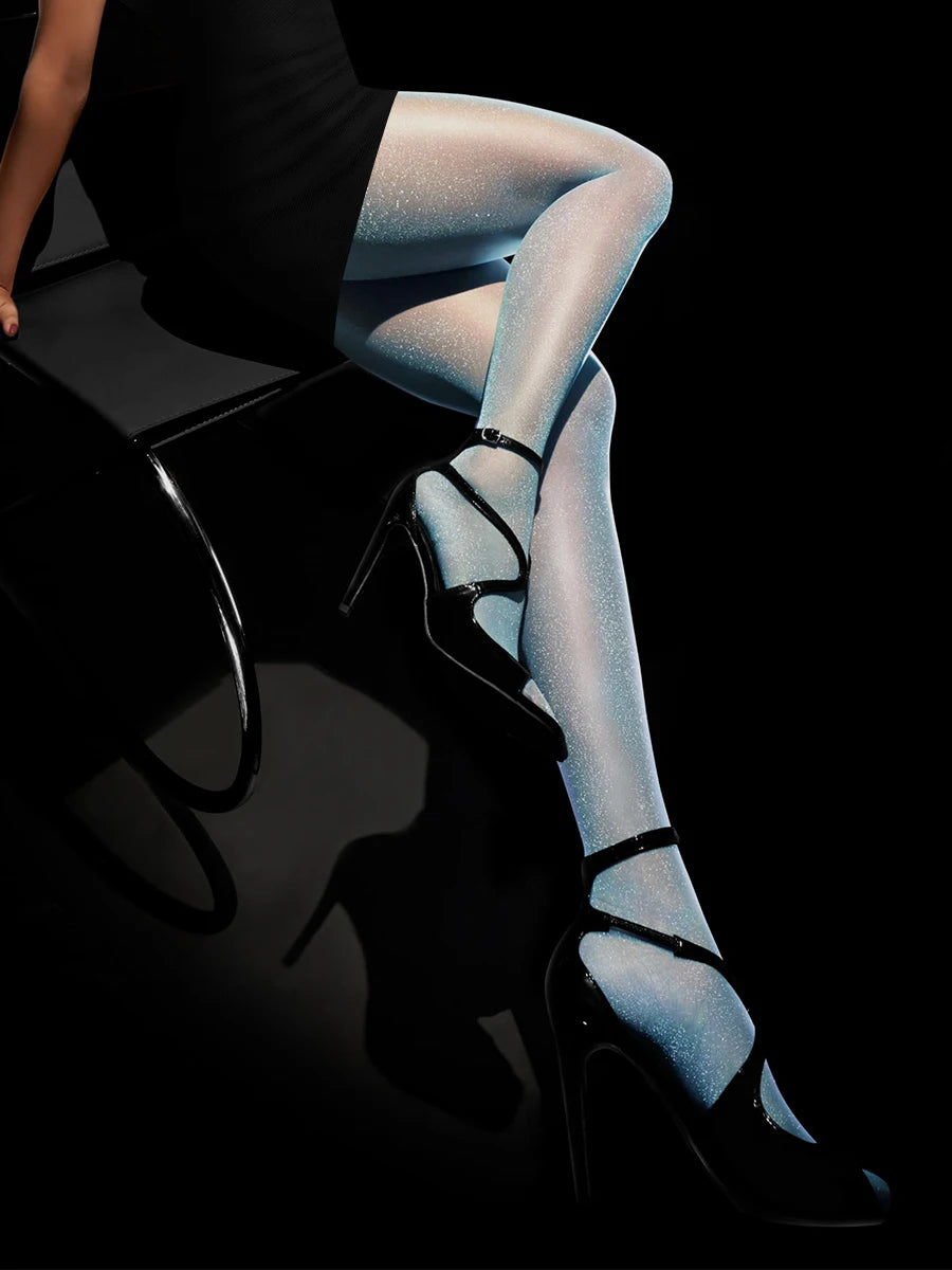 Pair of transparent, shiny, nude-colored women's stockings from Corporación Turística, showcasing their smooth, sexy fit.