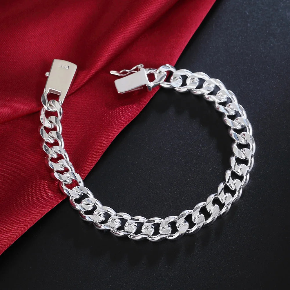 Solid sterling silver chain bracelet from Corporación Turística, 8-10mm width, with detailed links on a neutral background.