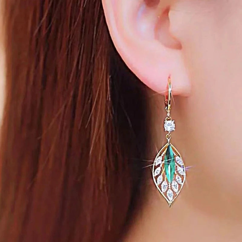 Green zircon leaf pendant earrings for women, black metal hooks, elegant jewelry accessory.