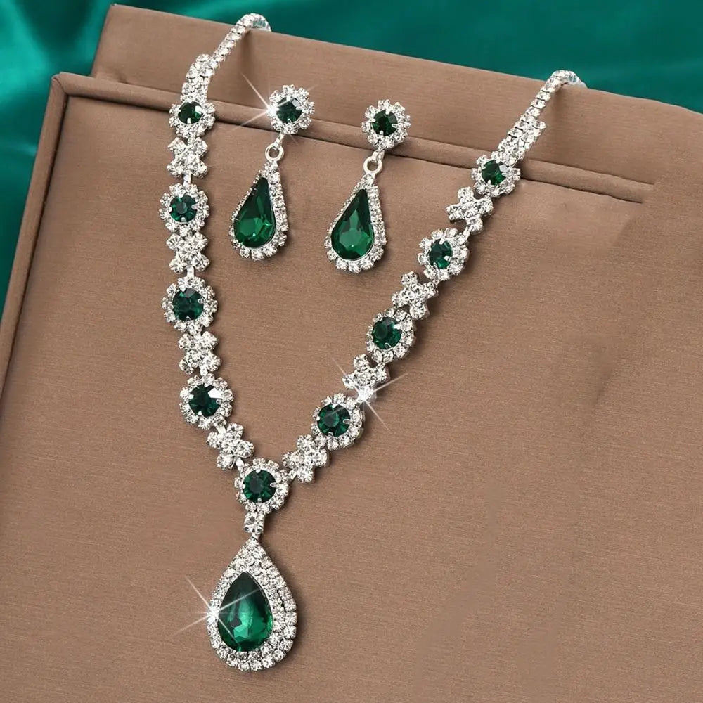 Elegant jewelry set with crystal pendant necklace and matching earrings from Corporación Turística, featuring sparkling crystal details.