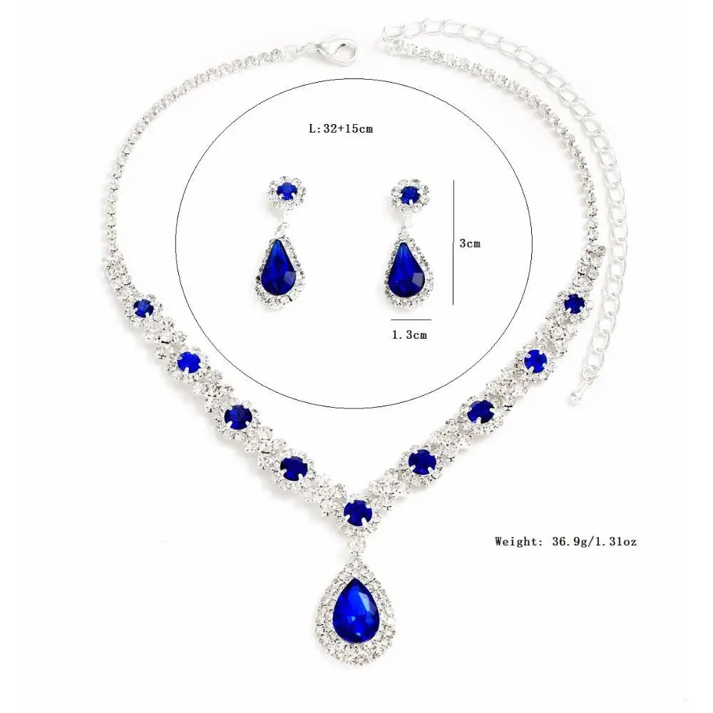 Elegant jewelry set with crystal earrings and necklace from Corporación Turística, featuring sparkling crystal designs.