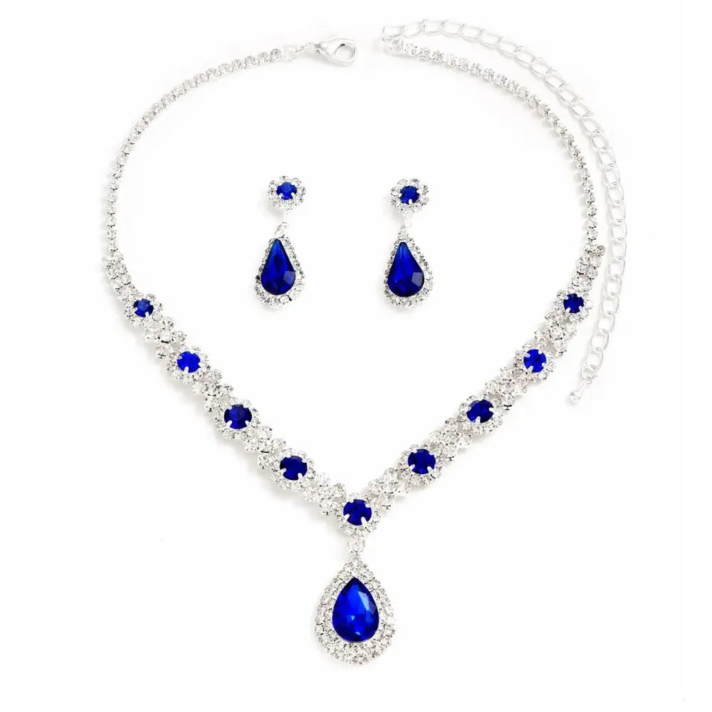 Crystal jewelry set with matching earrings and necklace from Corporación Turística, featuring elegant, sparkling glass design.