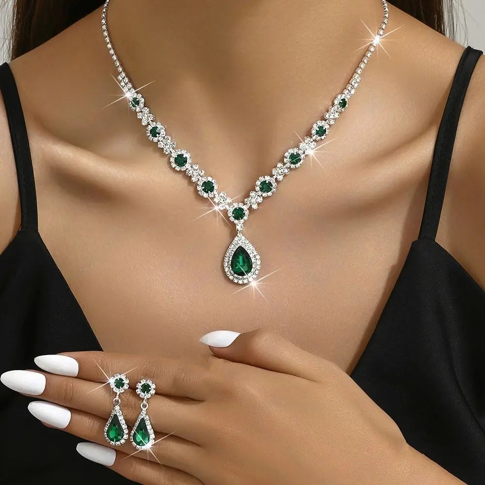 Elegant crystal jewelry set featuring matching earrings and necklace from Corporación Turística, displayed on a neutral background.