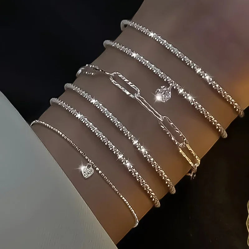 Six imitation diamond silver bracelets from Corporación Turística, featuring sparkling cubic zirconia accents and sleek silver bands.