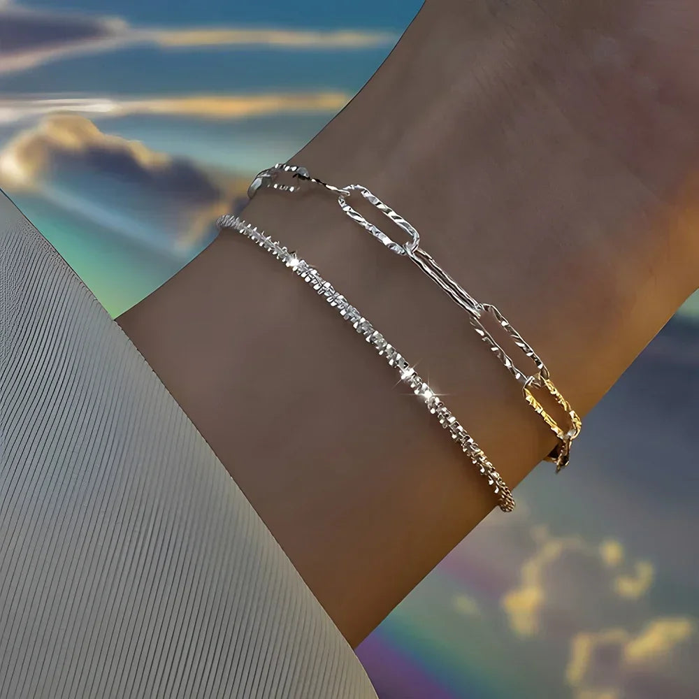 Six imitation diamond silver bracelets from Corporación Turística, showcasing sparkling jewelry with elegant design.