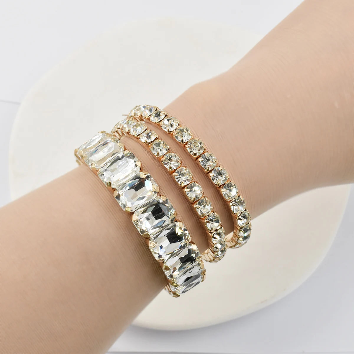 Set of three women's crystal bracelets featuring geometric designs, made by Corporación Turística, displayed on a plain background.