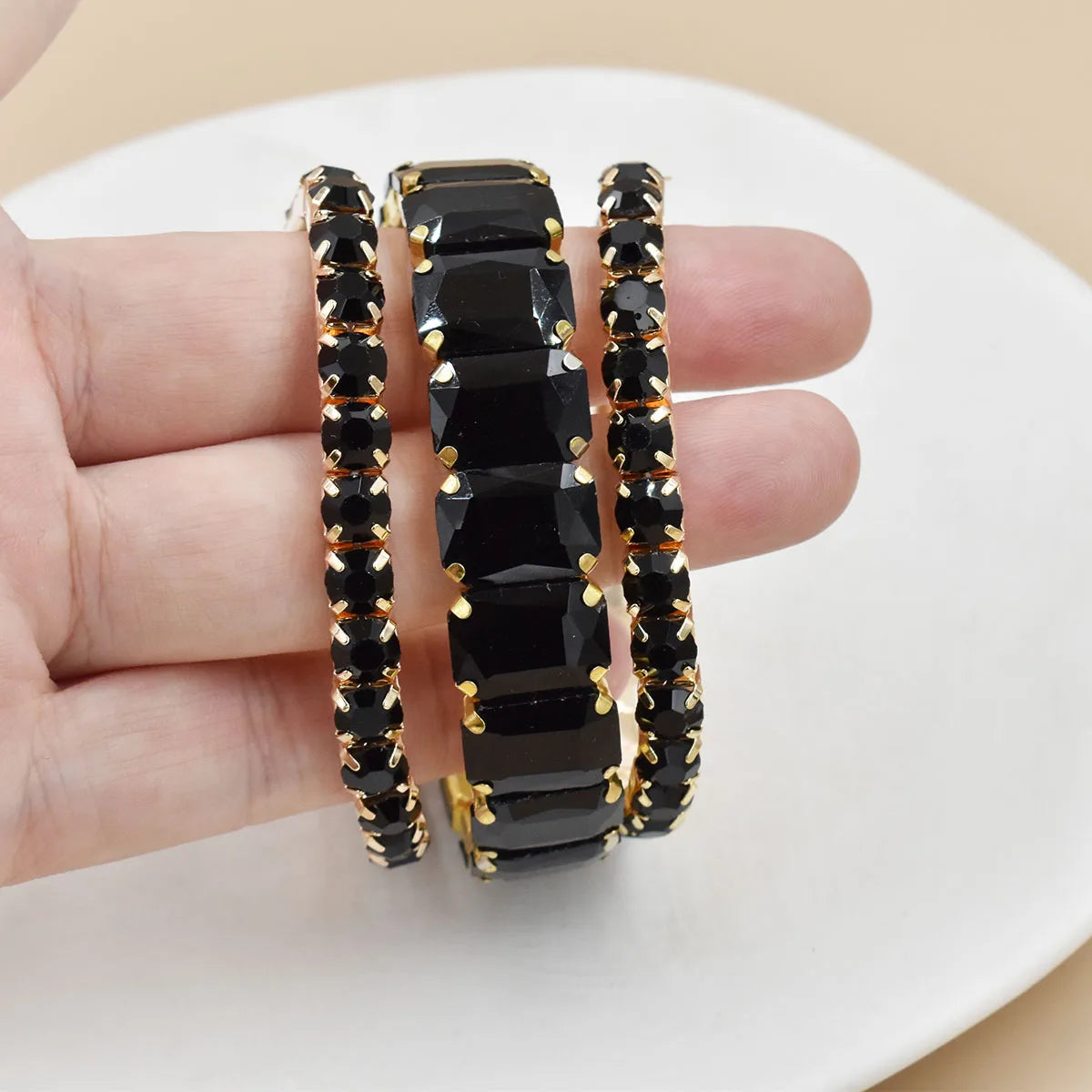 Set of three women's crystal bracelets with geometric design by Corporación Turística, featuring transparent and glittering crystal beads.