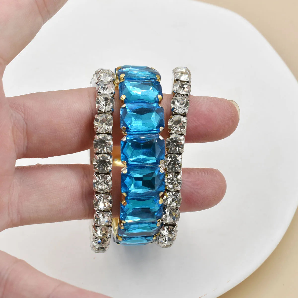 Set of three women's crystal bracelets with geometric designs, featuring sparkling crystal beads and elegant metal accents.
