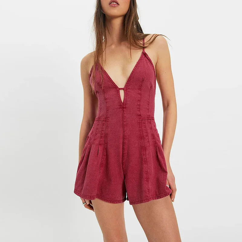Dark green women's party jumpsuit with lace-up front and open back, designed by Corporación Turística.