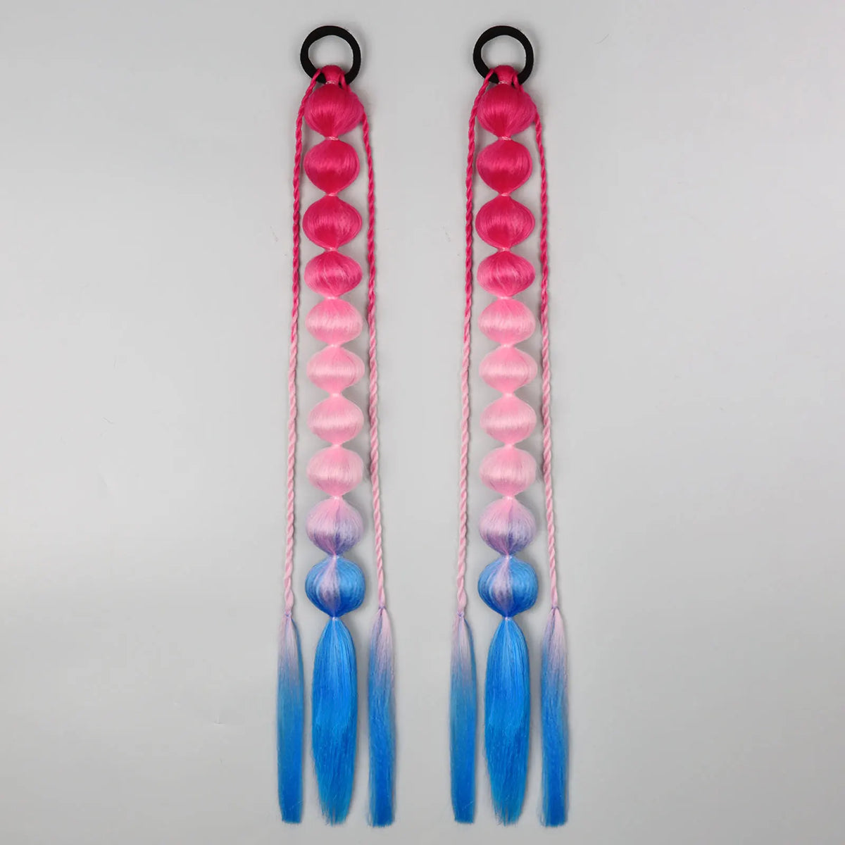 Synthetic bubble ponytail extensions from Corporación Turística, showing vibrant, textured hair extensions for added volume.