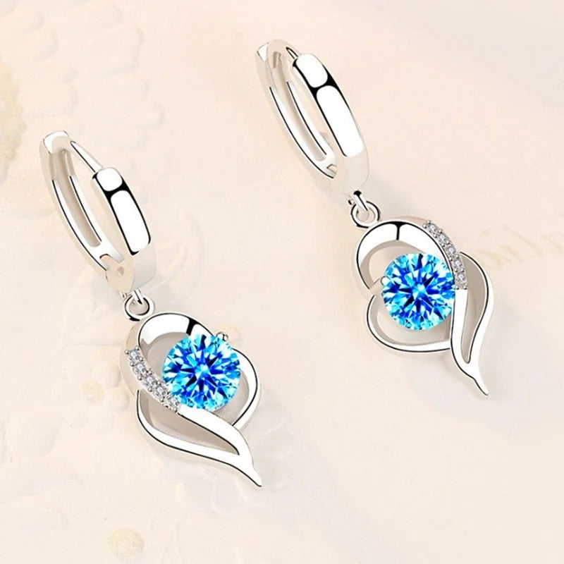 Sterling silver 925 earrings with sparkling crystal cubic zirconia, featuring elegant dangling design.