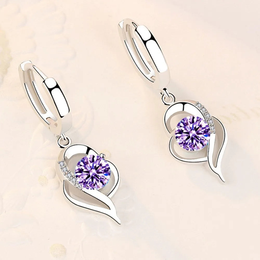 Sterling silver 925 earrings with sparkling crystal cubic zirconia, featuring elegant dangle design and polished finish.
