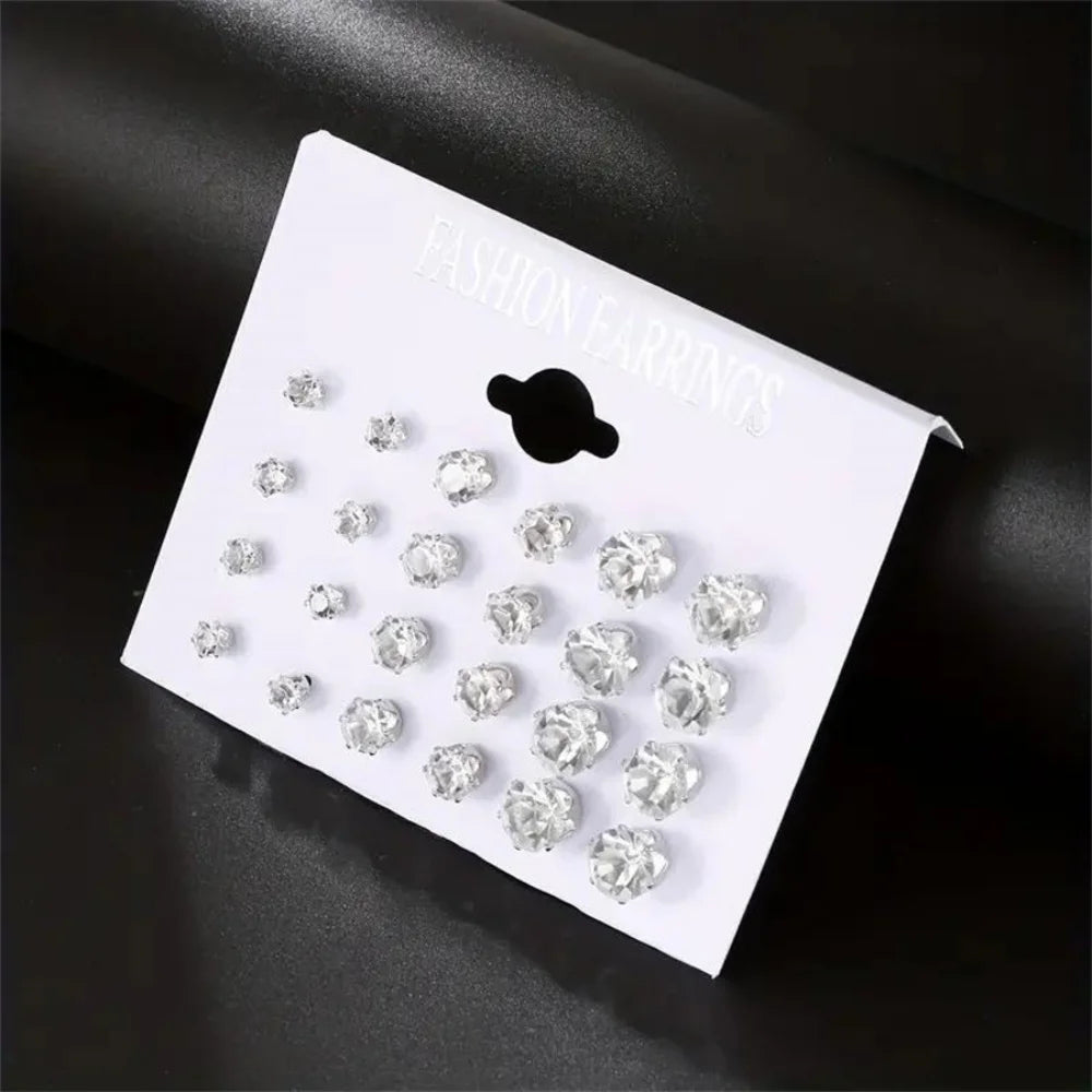 Set of 12 pairs of zirconia stud earrings from Corporación Turística, featuring classic screw-back design in a variety of styles.