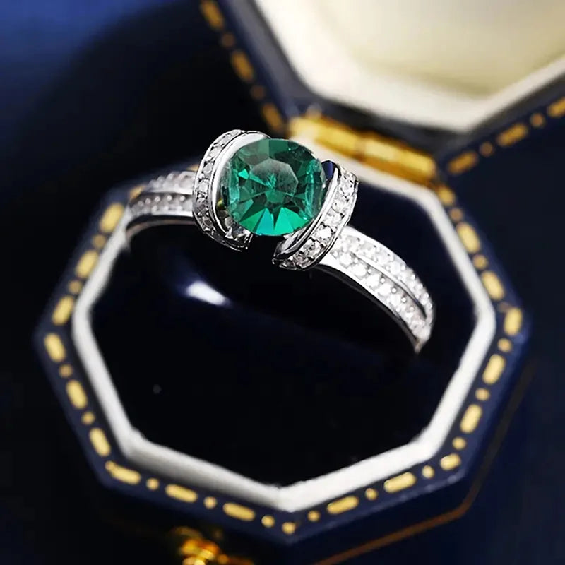 Sterling silver green cubic zirconia ring with band design, crafted by Corporación Turística.