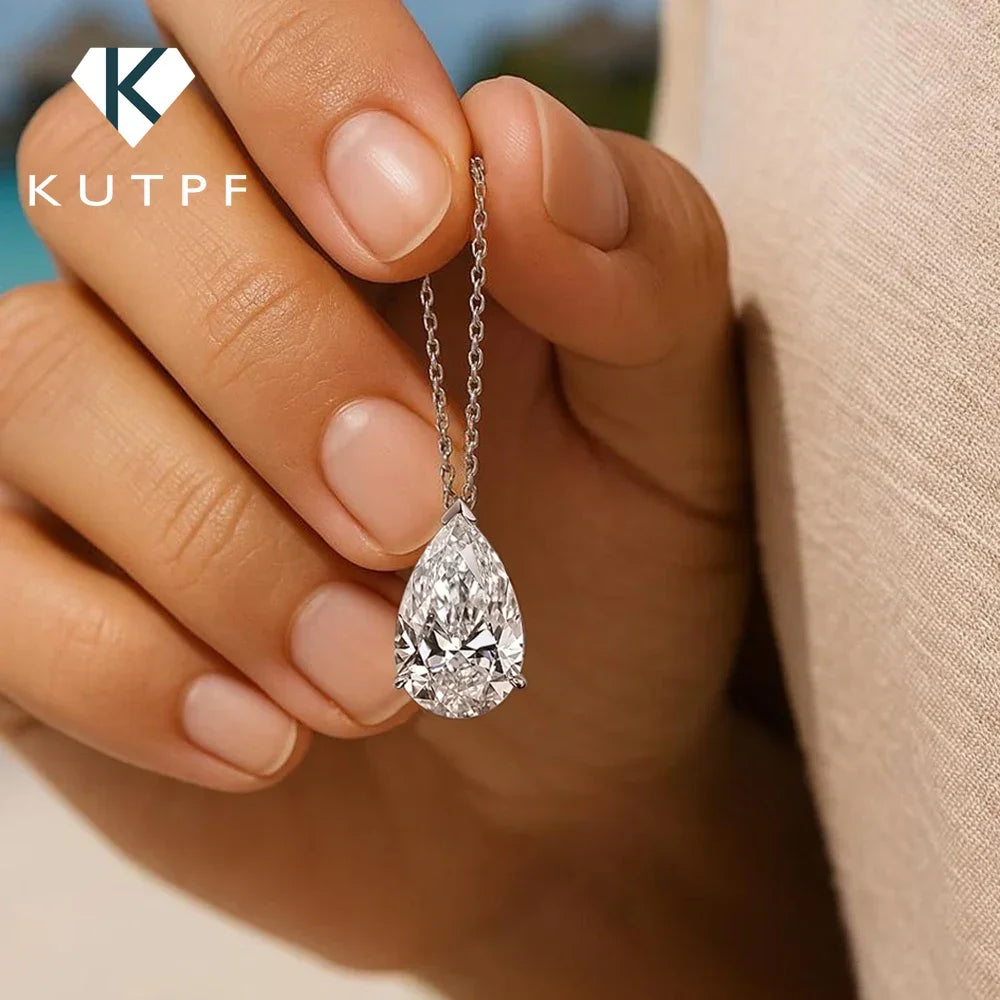 Silver moissanite drop pendant necklace featuring a teardrop-shaped gemstone, elegant jewelry accessory.