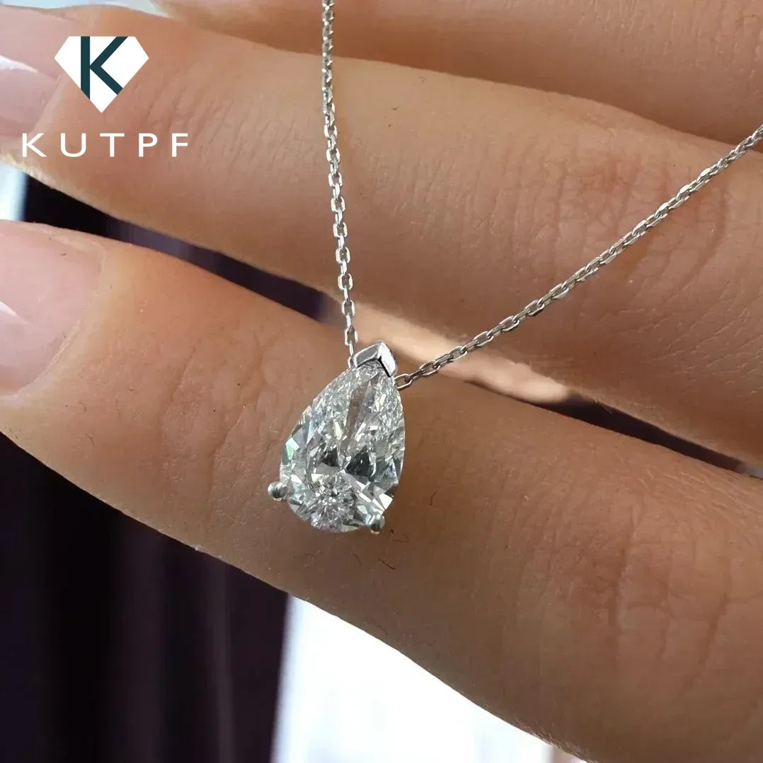 Silver moissanite pendant necklace with teardrop-shaped gemstone on a delicate chain, elegant jewelry piece.