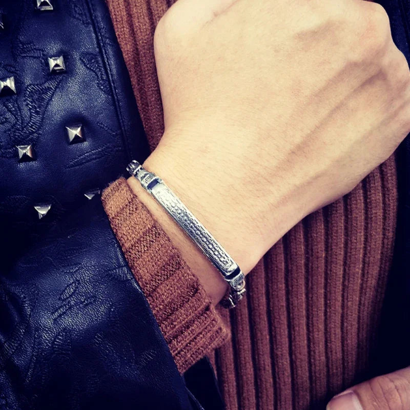 Silver-colored men's fashion bracelet from Corporación Turística, showcasing sleek metal design and adjustable fit.