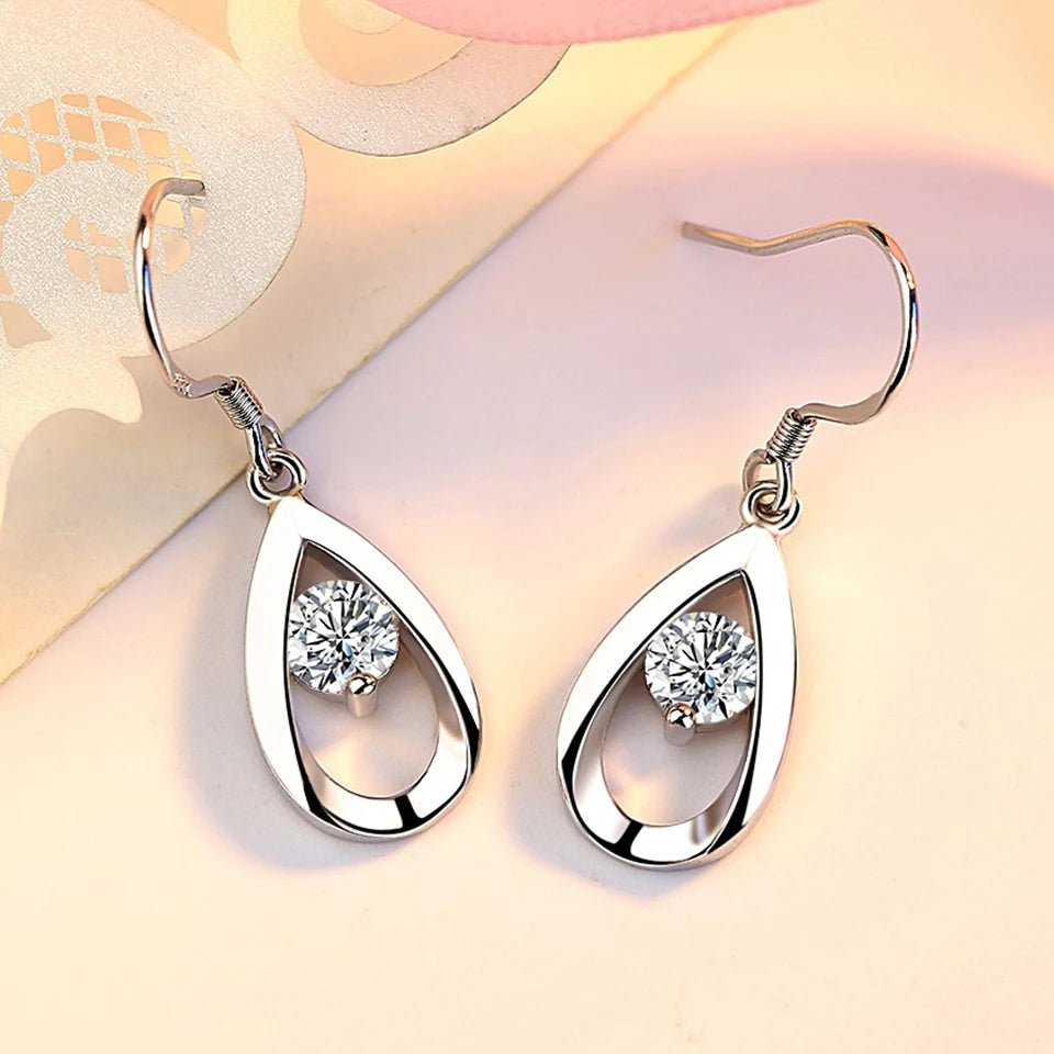Water drop-shaped zircon earrings for women, silver-tone dangle jewelry with sparkling stones, stylish and elegant accessory.