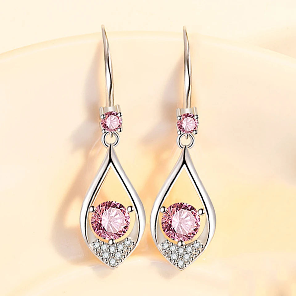 Water drop-shaped zircon earrings for women, elegant dangle earrings with sparkling stones, crafted by Corporación Turística.