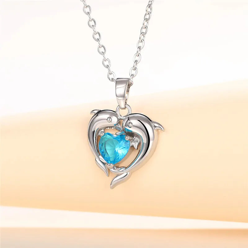Sterling silver 925 dolphin and heart-shaped necklace from Corporación Turística, featuring detailed ocean-inspired design.