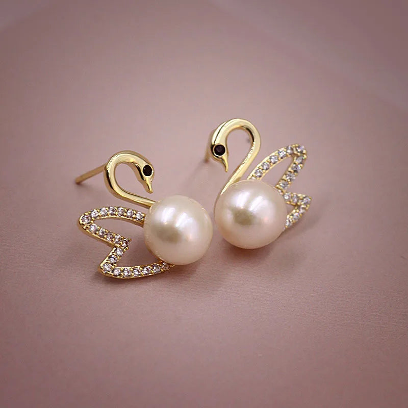 Silver 92% crystal hollow swan earrings with needle design, featuring elegant green accents, perfect for sophisticated jewelry styles.