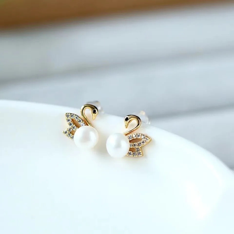 Silver 92% crystal hollow swan earrings with needle design, featuring elegant green crystal accents.