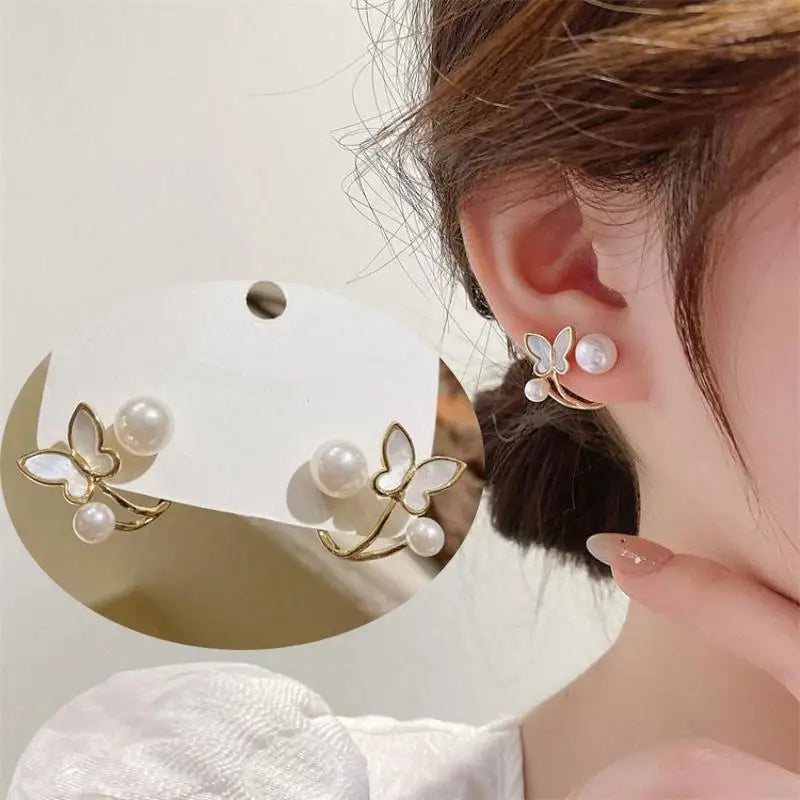 Silver 92% crystal hollow swan earrings with needle design, featuring intricate detailing and a vibrant green color.