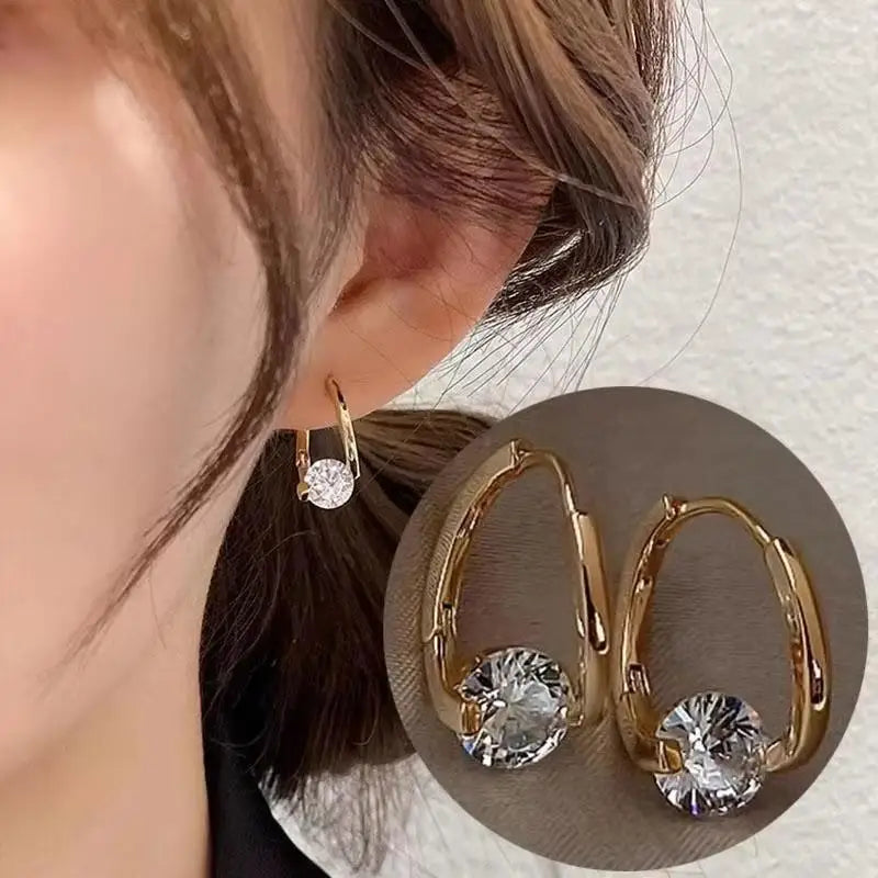 Silver 92% crystal hollow swan earrings with needle design, featuring a graceful bird shape and vibrant green accents.