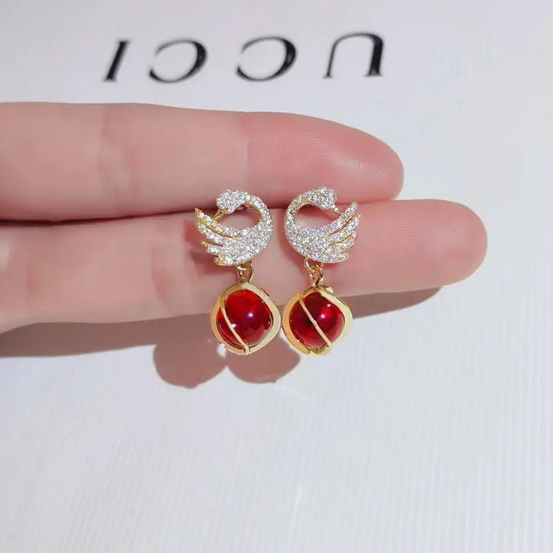 Silver 92% crystal hollow swan earrings with needle design, elegant jewelry piece featuring intricate craftsmanship.