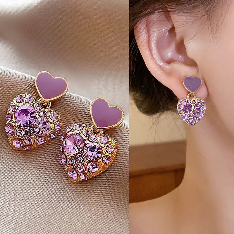 Purple crystal heart drop earrings for women, featuring elegant dangling design by Corporación Turística.