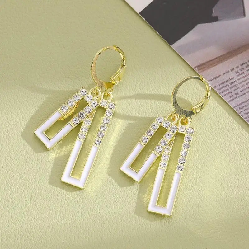 Purple crystal heart drop earrings for women, featuring elegant dangling design from Corporación Turística.