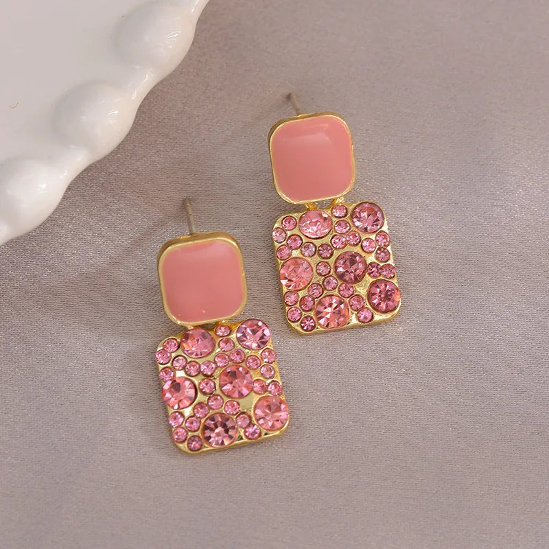 Purple crystal heart drop earrings for women, featuring elegant dangling design by Corporación Turística.