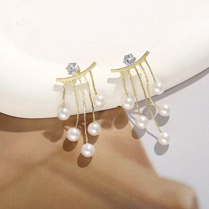 Elegant Korean fashion pearl tassel earrings with needle hook, featuring 5mm crystal beads for a stylish look.