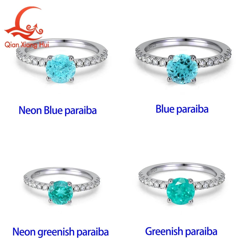 Silver ring featuring a 6.5mm Neon Blue Paraiba Tourmaline with vivid greenish-blue hues, set in a polished silver band.