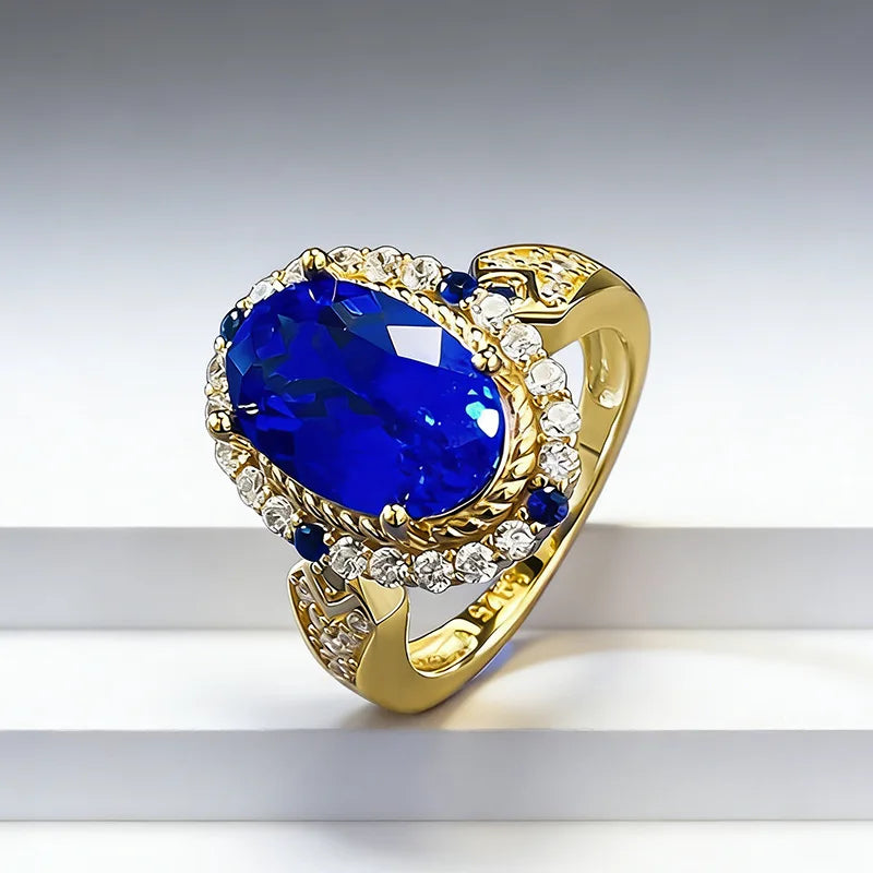 Luxury 24K gold ring with blue gemstone and certified solid gold, featuring a detailed band design, from Corporación Turística.