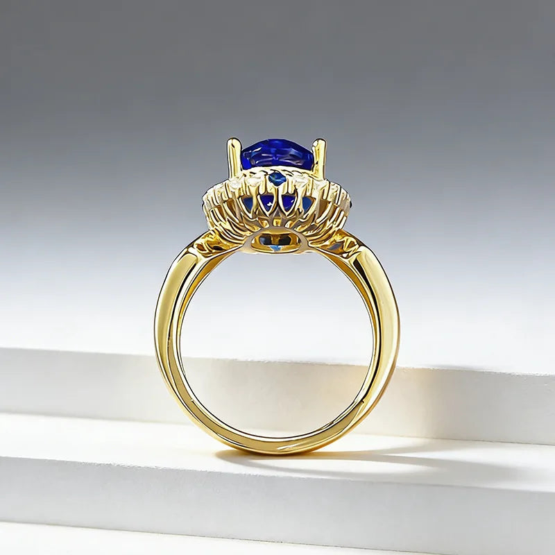 Luxury 24K gold ring with a blue gemstone and certified solid gold, featuring a detailed band design.