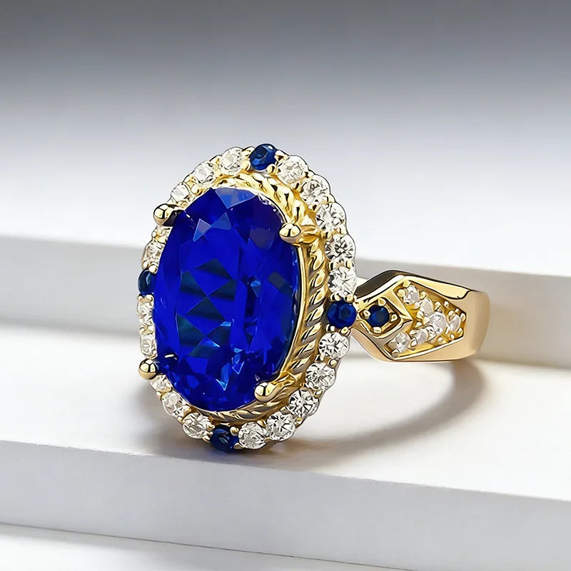 Luxury 24K gold ring with a solid 9999 certification and decorative foot, featuring a vibrant blue gemstone setting.