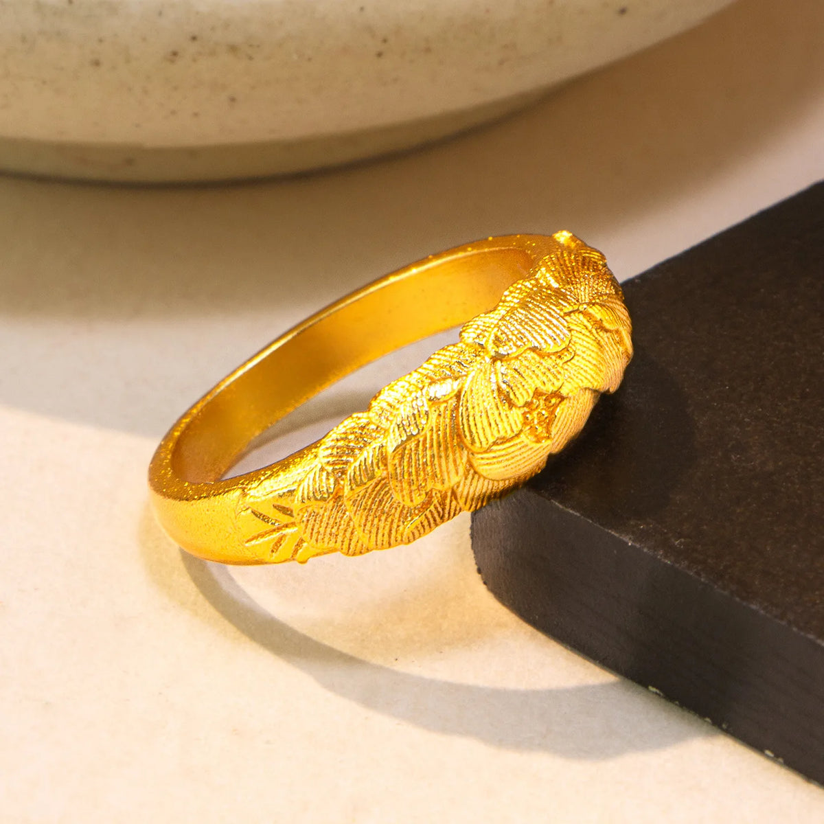 Gold solid ring with detailed peony relief for women, featuring intricate floral design in a natural pose.