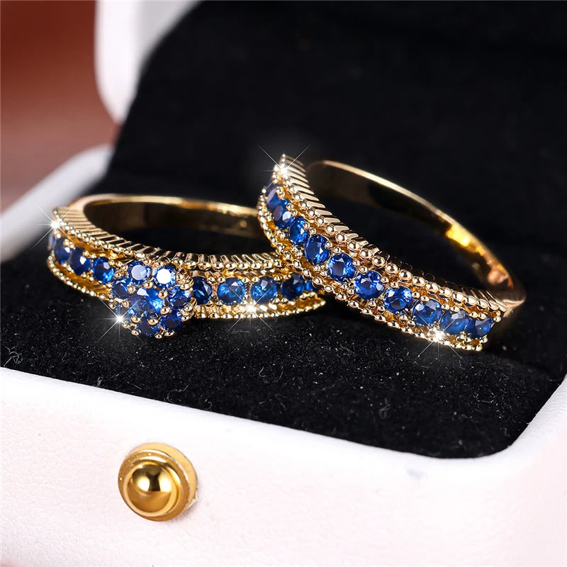 Set of turquoise cubic zirconia engagement rings by Corporación Turística, showing detailed close-up of sparkling stones and silver bands.